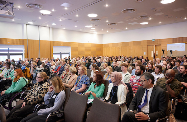 a large audience in a conference room
