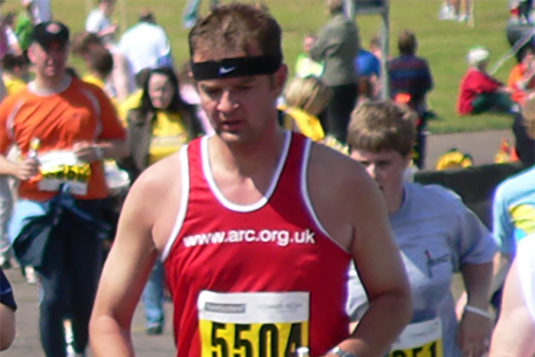 David Brook, in a running vest, taking part in a race