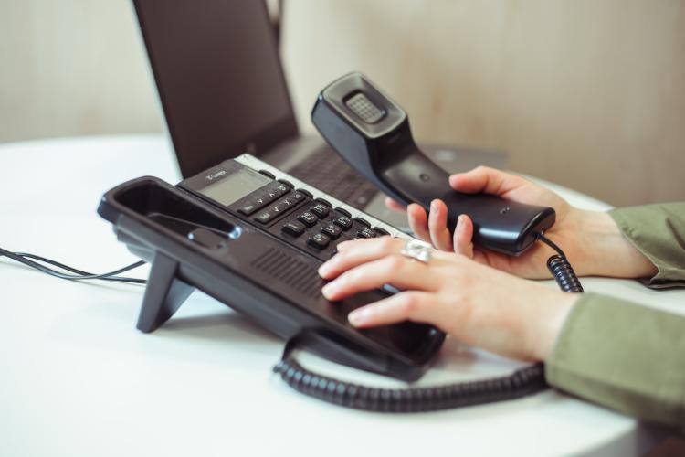 Close up of someone dialing on a landline phone