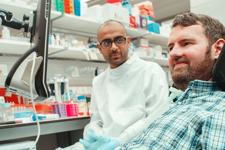 Euan MacDonald and a researcher in a lab