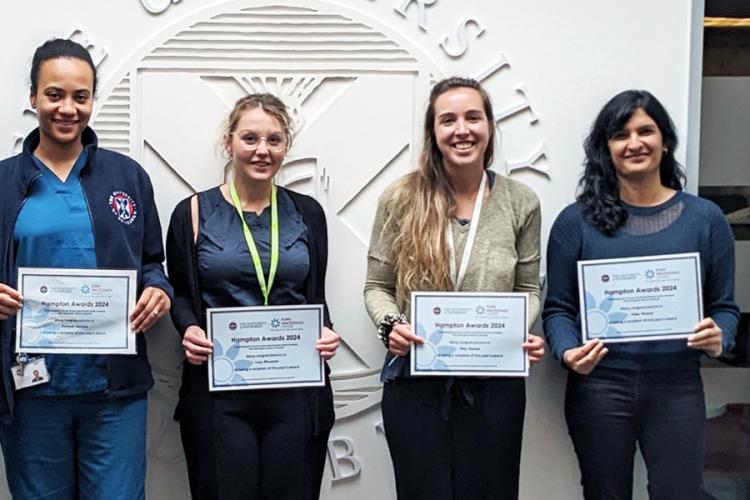 Hampton Award winners 2018: five people standing and smiling, next to a Euan MacDonald Centre banner