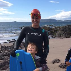 Picture of Laura Weir in wetsuit and swimming cap against backdrop of water