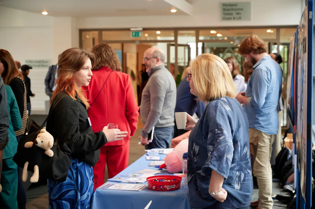A Euan MacDonald Centre community fundraising stall with people sharing their fundraising ideas.