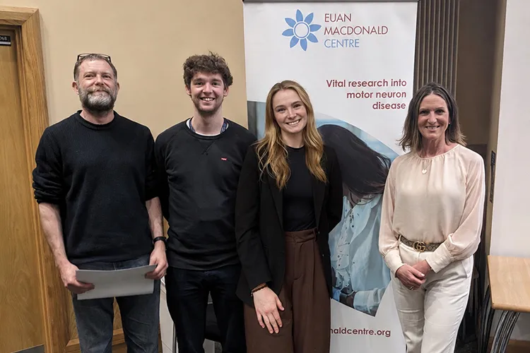 Hampton award winners standing smiling next to a Euan MacDonald Centre banner. Winners are Rod Carter, Mungo Harvey and Alyssa Corbett (L-R) with Judy Newton (R) who presented the awards.